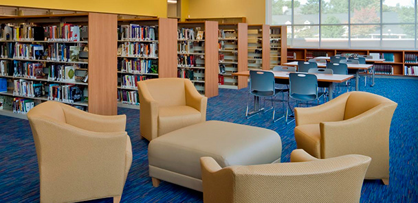 The new library with seating areas for students including couches and book shelves.