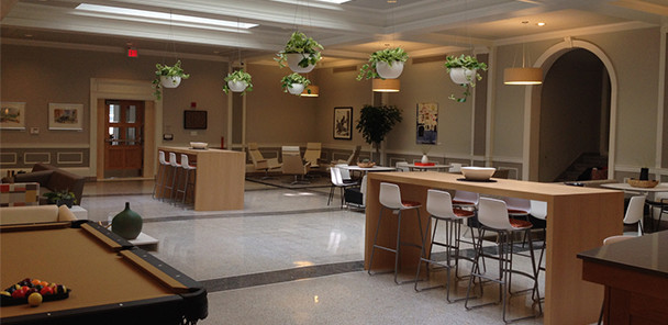 Common area with pool table and multiple seating areas.