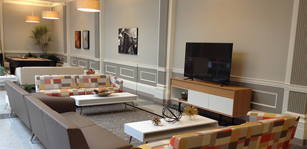 Common area with a television and multiple seating areas.